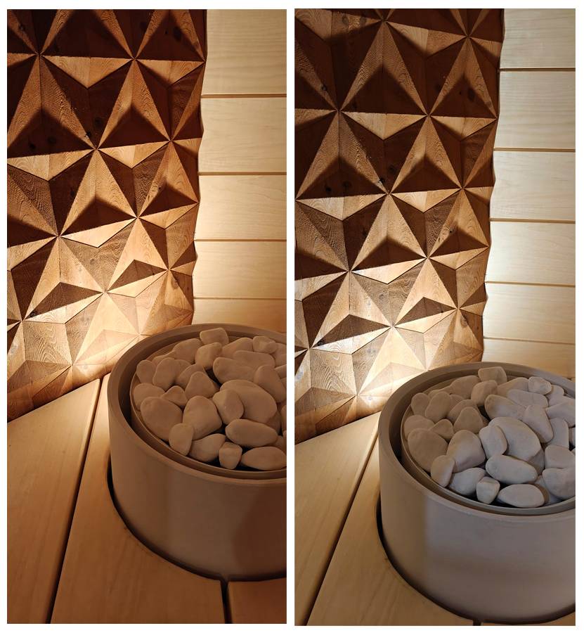 La pared de refuerzo situada detrás de la estufa está iluminada por un foco que ilumina hacia arriba.